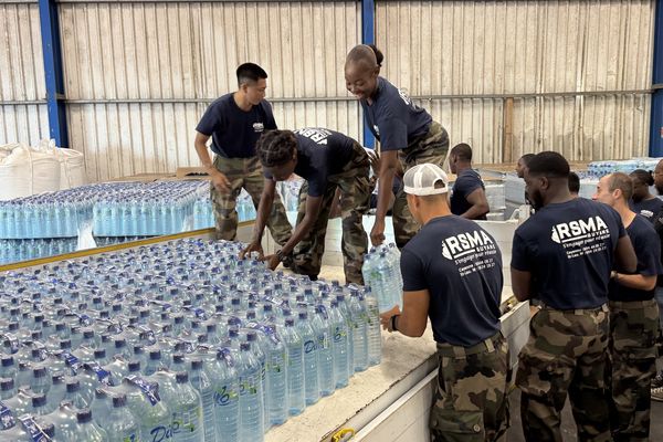 Les jeunes du RSMA chargent les packs d'eau destinés aux écoles de Saint-Laurent-du-Maroni, mobilisés face à la crise de l'eau.